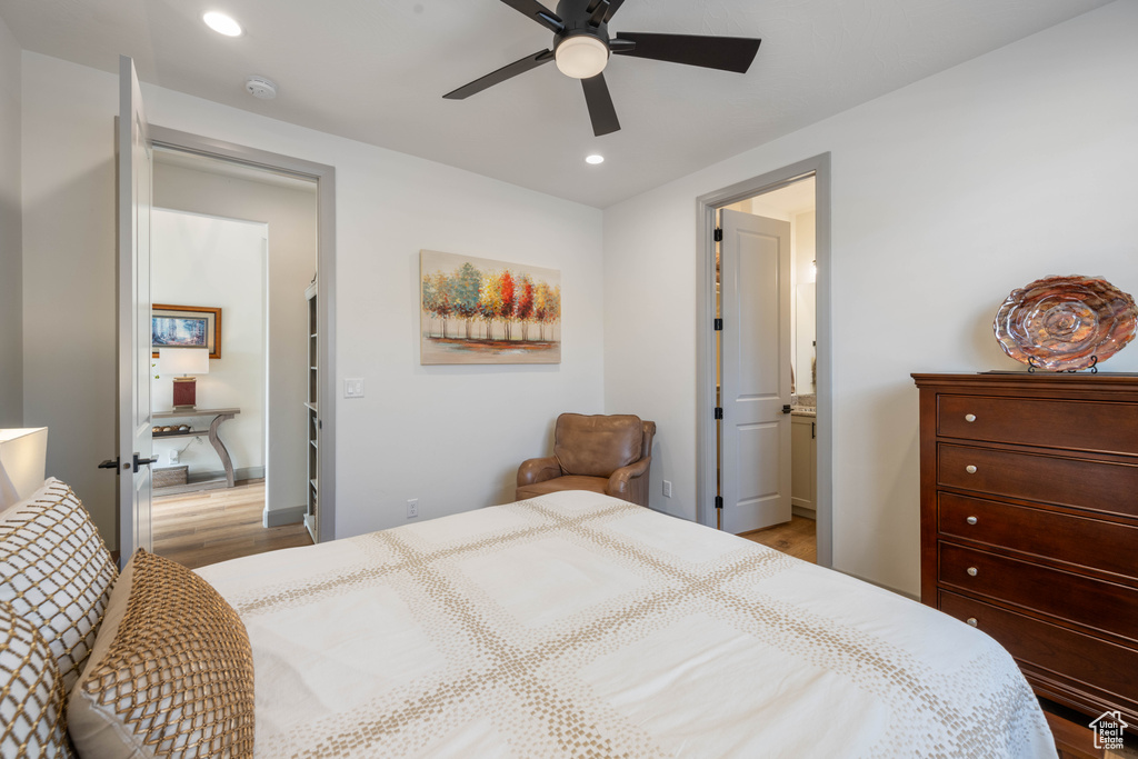 Bedroom with light hardwood / wood-style floors and ceiling fan