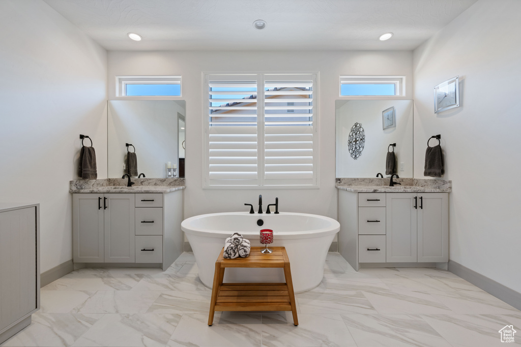 Bathroom featuring vanity and a washtub