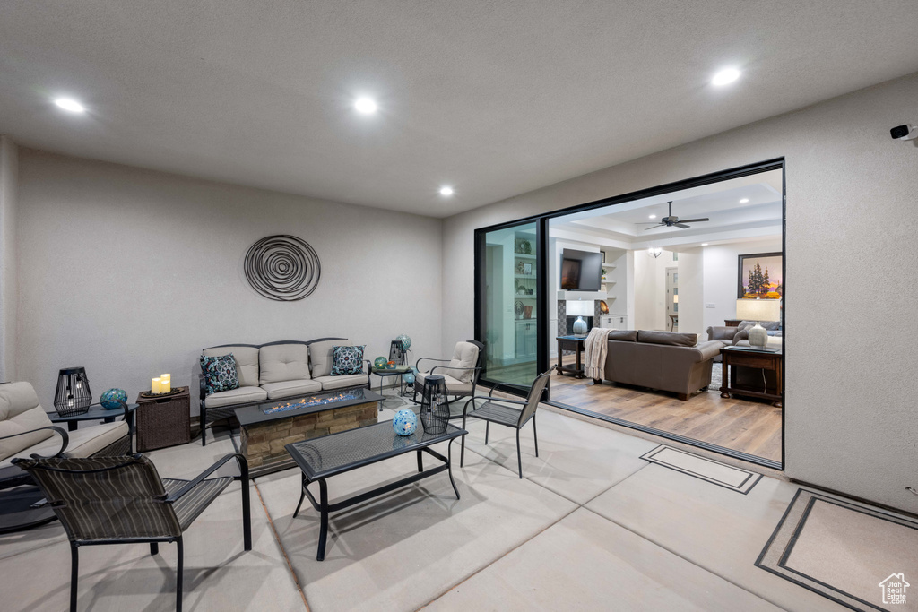 Living room with wood-type flooring and ceiling fan