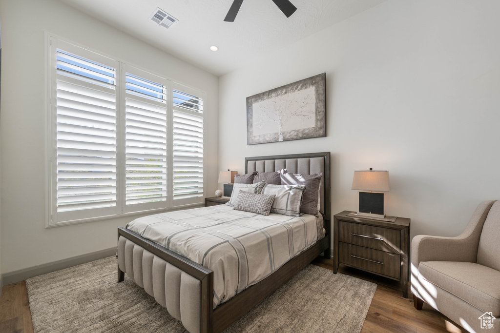 Bedroom with dark wood-type flooring and ceiling fan