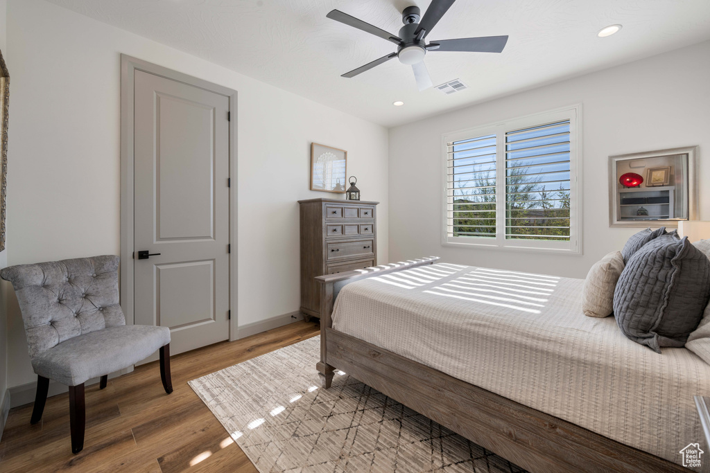 Bedroom with ceiling fan and wood-type flooring