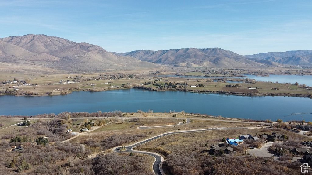 Drone / aerial view with a water and mountain view