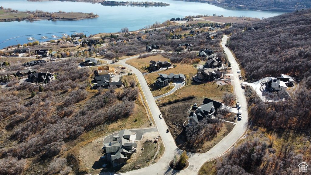 Birds eye view of property with a water view