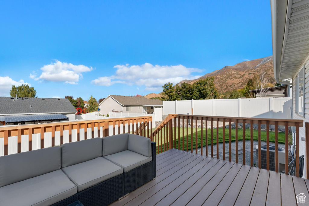 Wooden deck featuring an outdoor living space and a mountain view