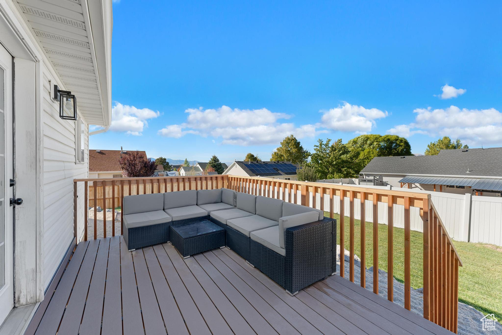 Wooden deck featuring a yard and an outdoor living space