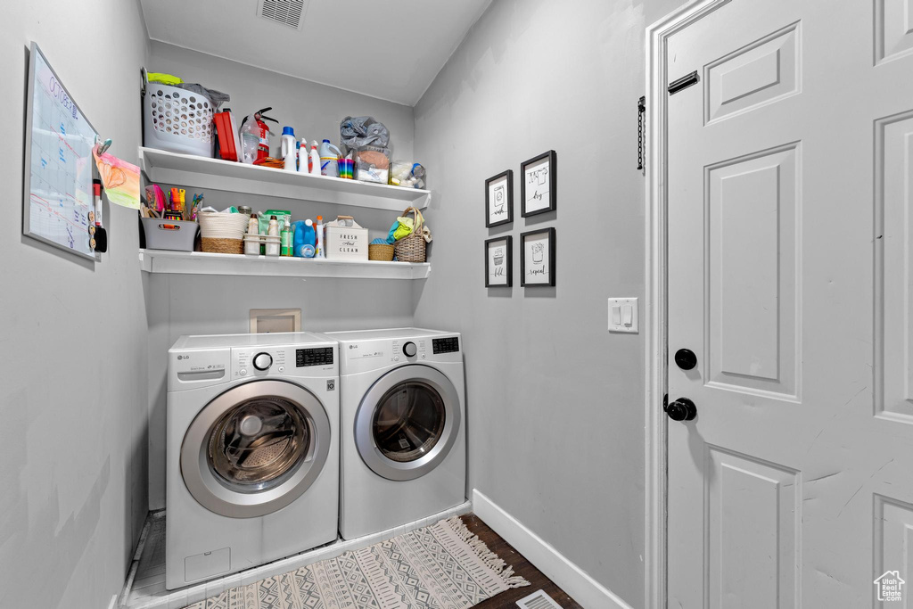 Clothes washing area featuring separate washer and dryer