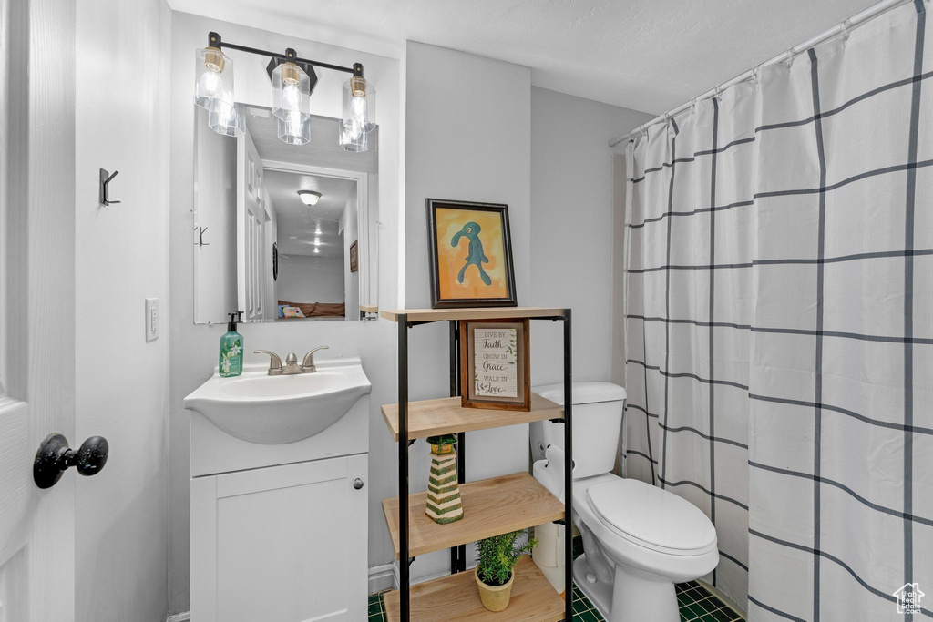 Bathroom featuring vanity, toilet, and walk in shower