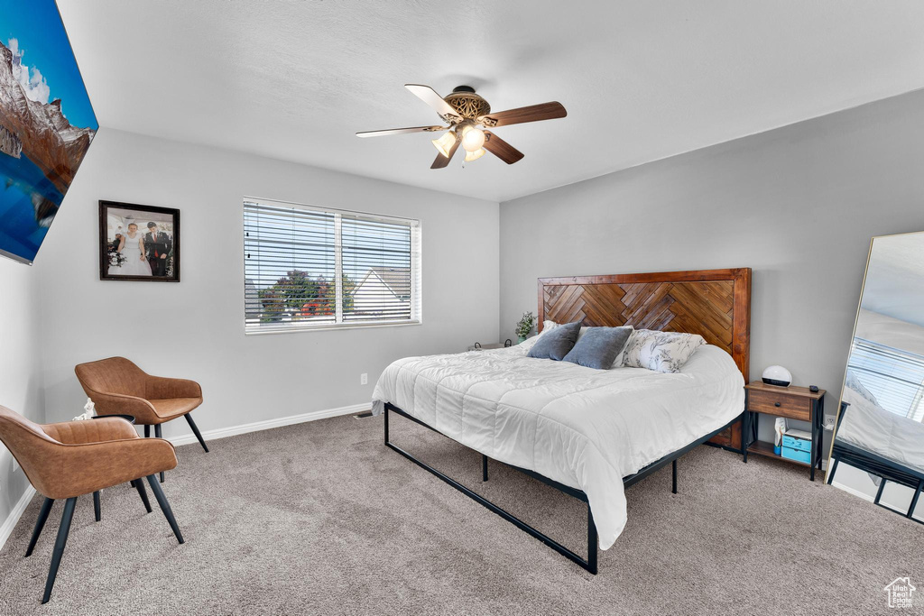 Carpeted bedroom with ceiling fan