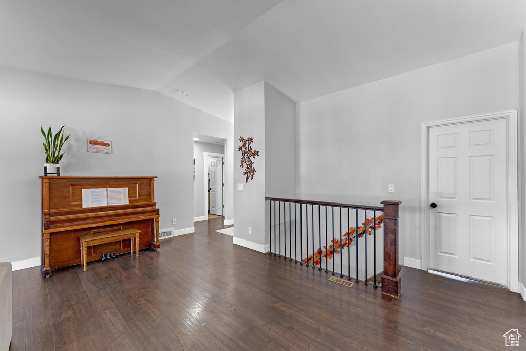 Hall featuring lofted ceiling and dark hardwood / wood-style floors