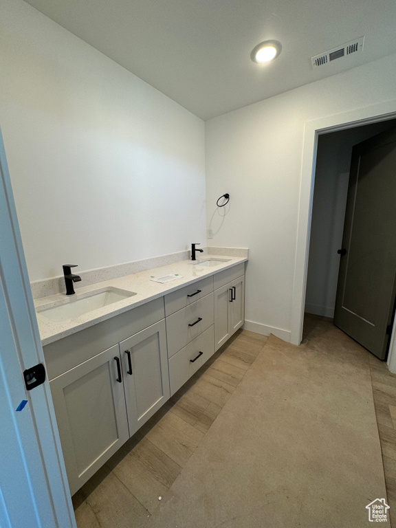 Bathroom with vanity and wood-type flooring