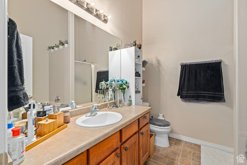 Bathroom with vanity, toilet, and walk in shower