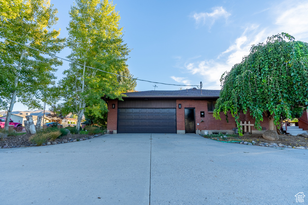 View of front facade featuring a garage