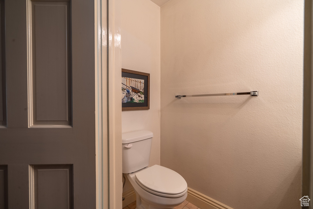 Bathroom featuring toilet and tile patterned flooring