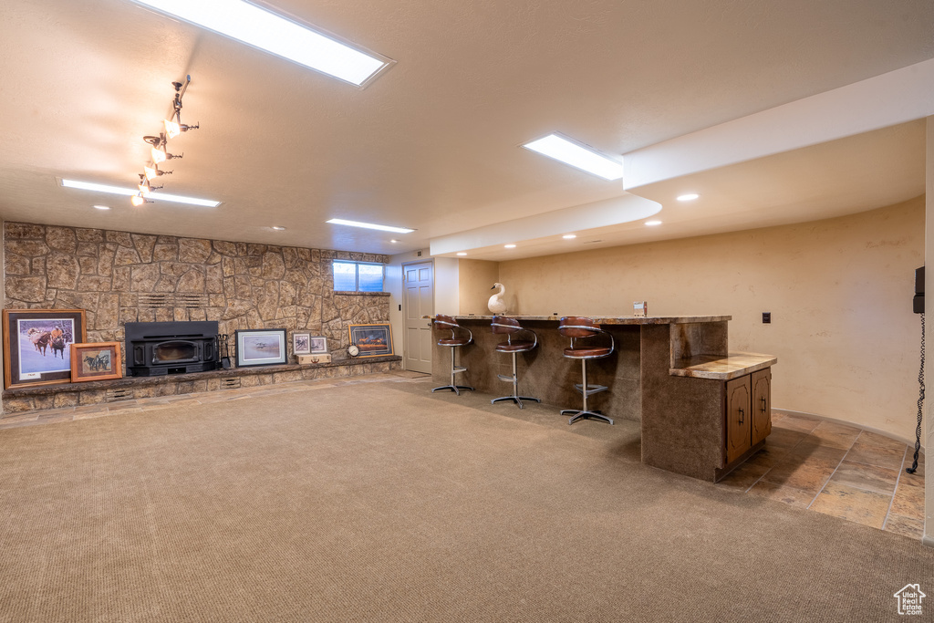 Bar featuring light carpet and a wood stove