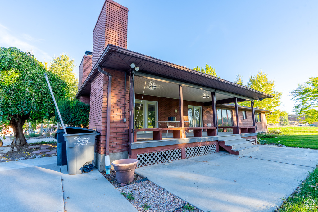 Back of property featuring a porch