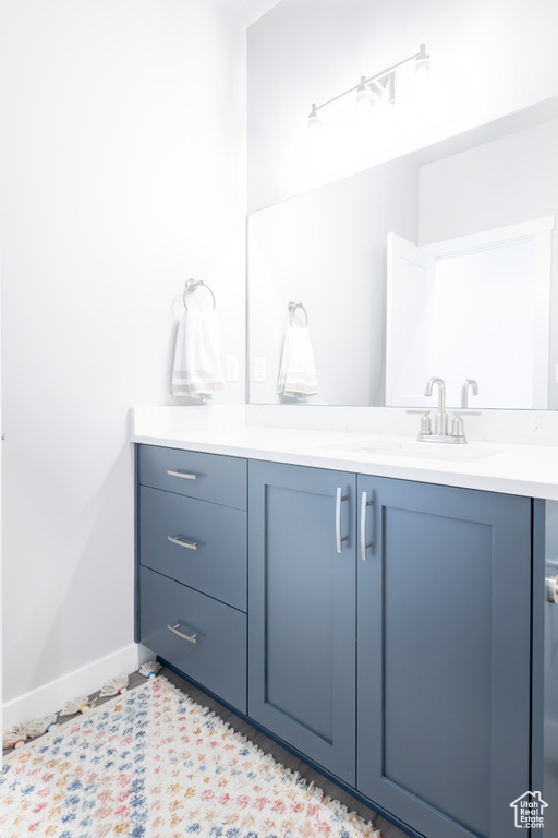 Bathroom featuring baseboards and vanity