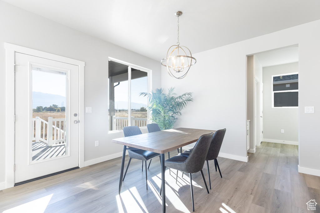 Dining space featuring a chandelier and light wood-type flooring