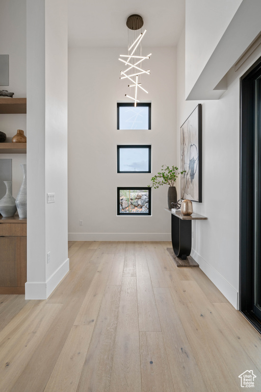 Foyer featuring light hardwood / wood-style floors and a chandelier