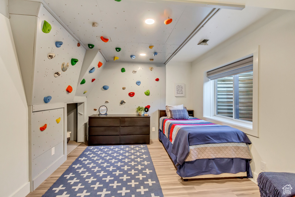 Bedroom with hardwood / wood-style floors