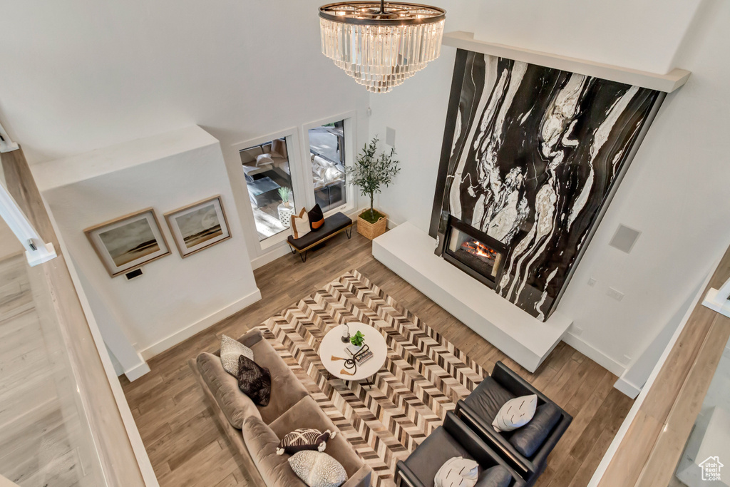 Interior space featuring a notable chandelier, hardwood / wood-style flooring, and a large fireplace