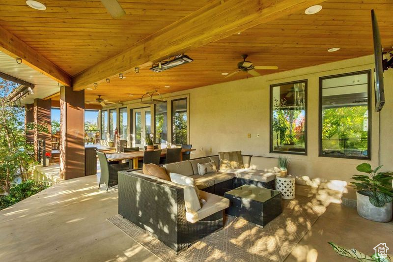 View of patio with an outdoor hangout area and ceiling fan