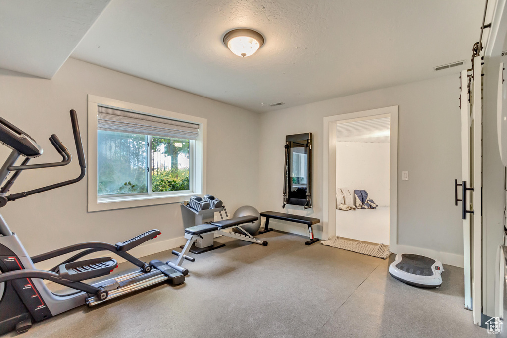 Exercise area featuring a textured ceiling