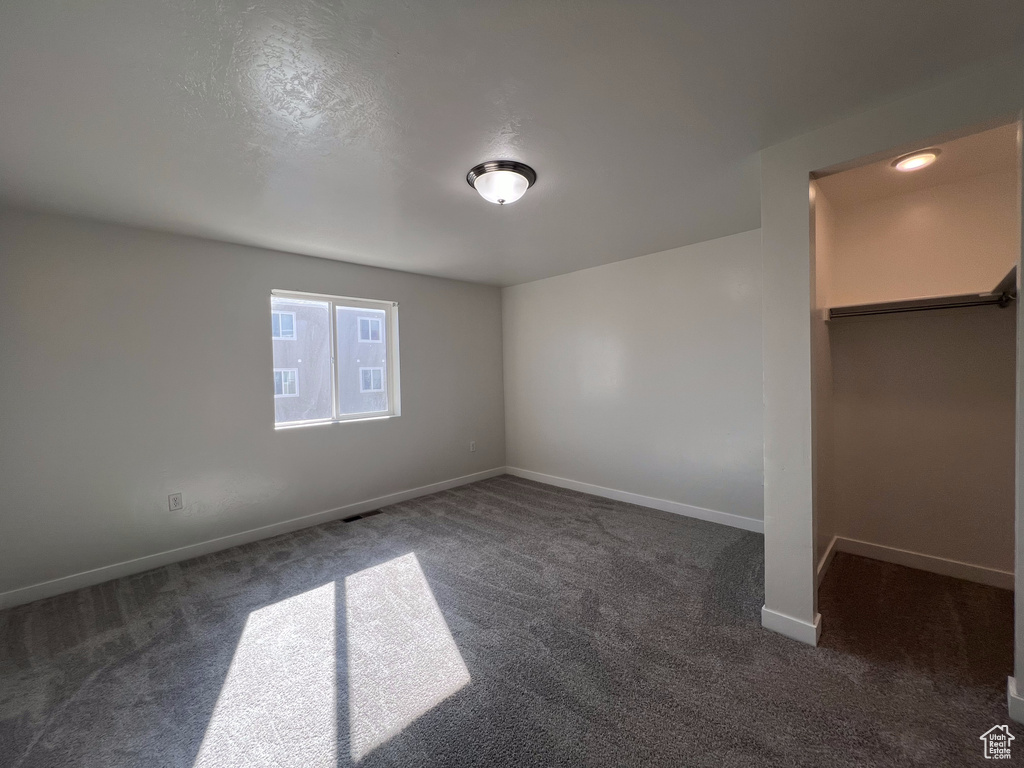 Unfurnished room with dark carpet