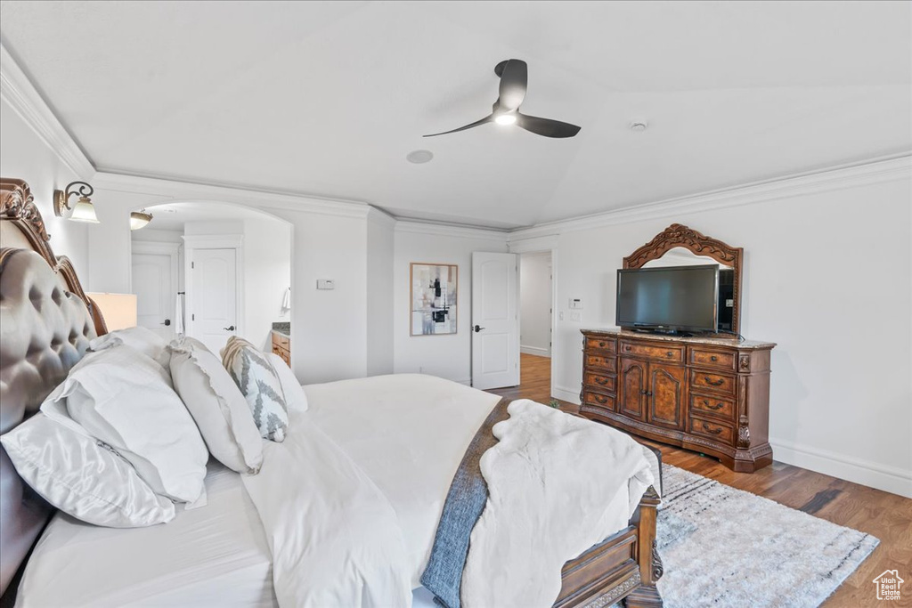 Bedroom featuring light hardwood / wood-style flooring, ornamental molding, and ceiling fan