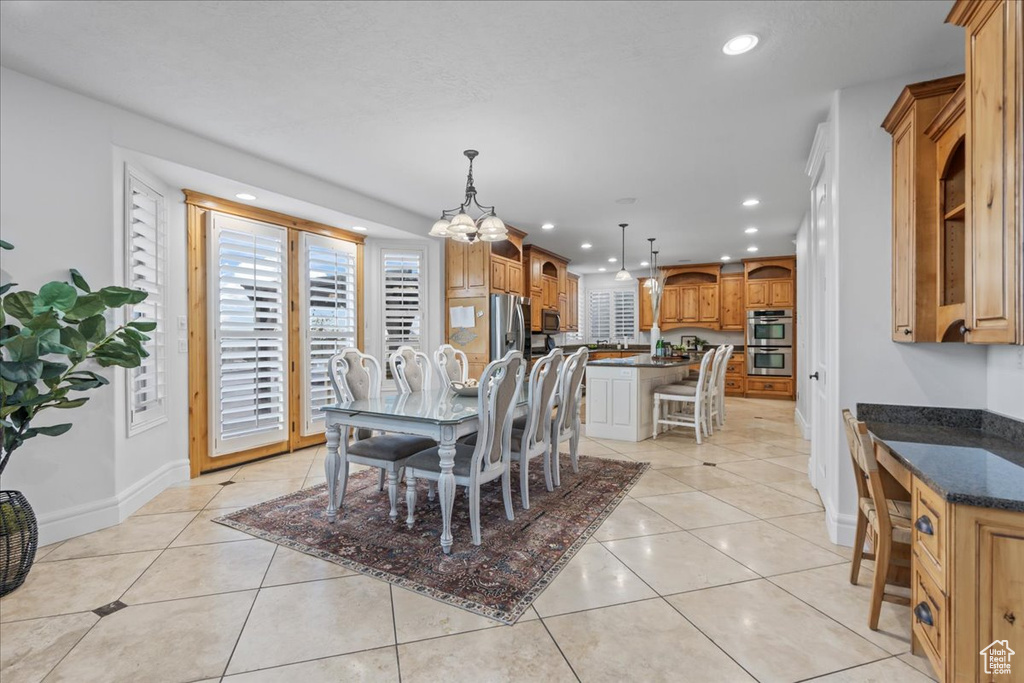 Dining room with a notable chandelier and light tile patterned flooring