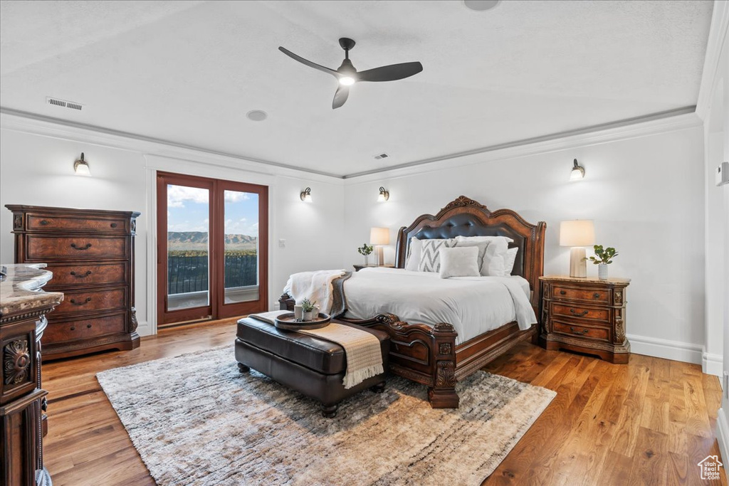 Bedroom featuring crown molding, access to exterior, light hardwood / wood-style floors, and ceiling fan