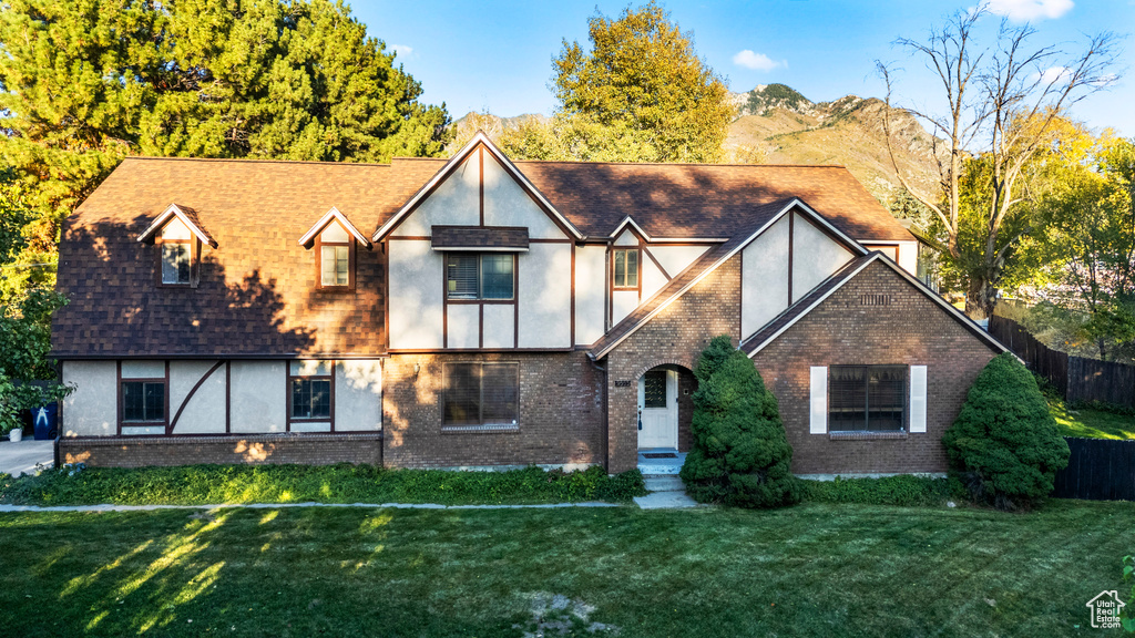 English style home with a front lawn