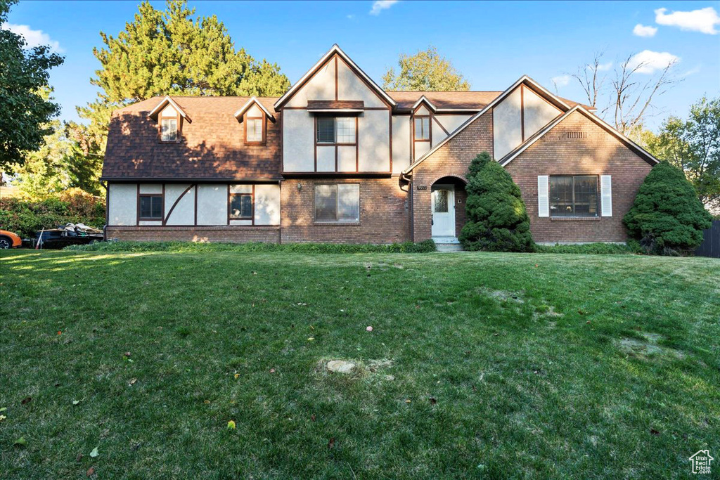 Tudor-style house with a front yard