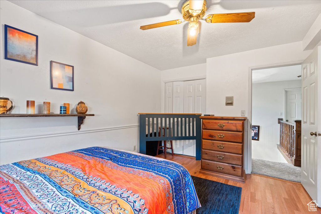 Bedroom featuring a closet, hardwood / wood-style floors, and ceiling fan