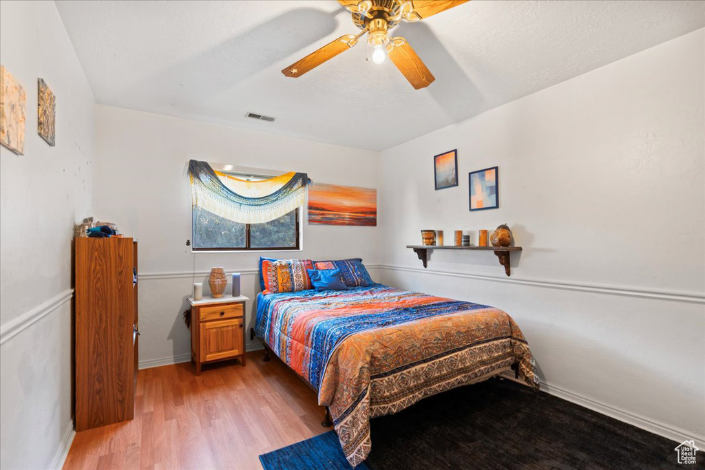 Bedroom featuring hardwood / wood-style flooring and ceiling fan