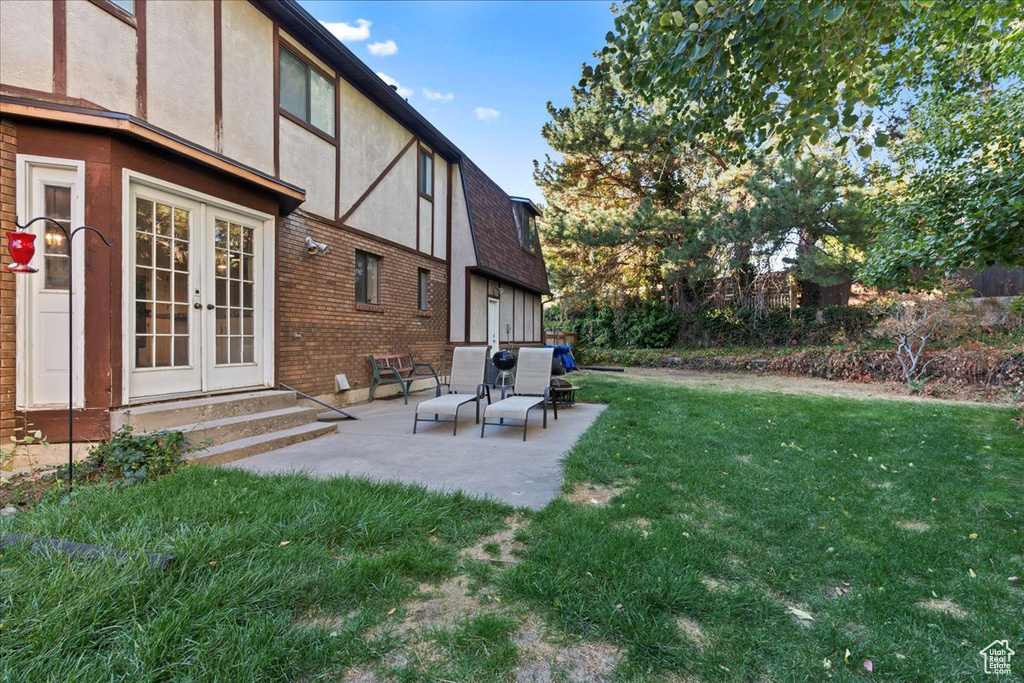 View of yard with a patio and french doors