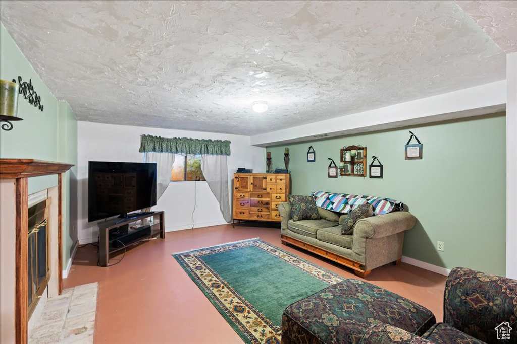 Living room featuring concrete flooring and a textured ceiling