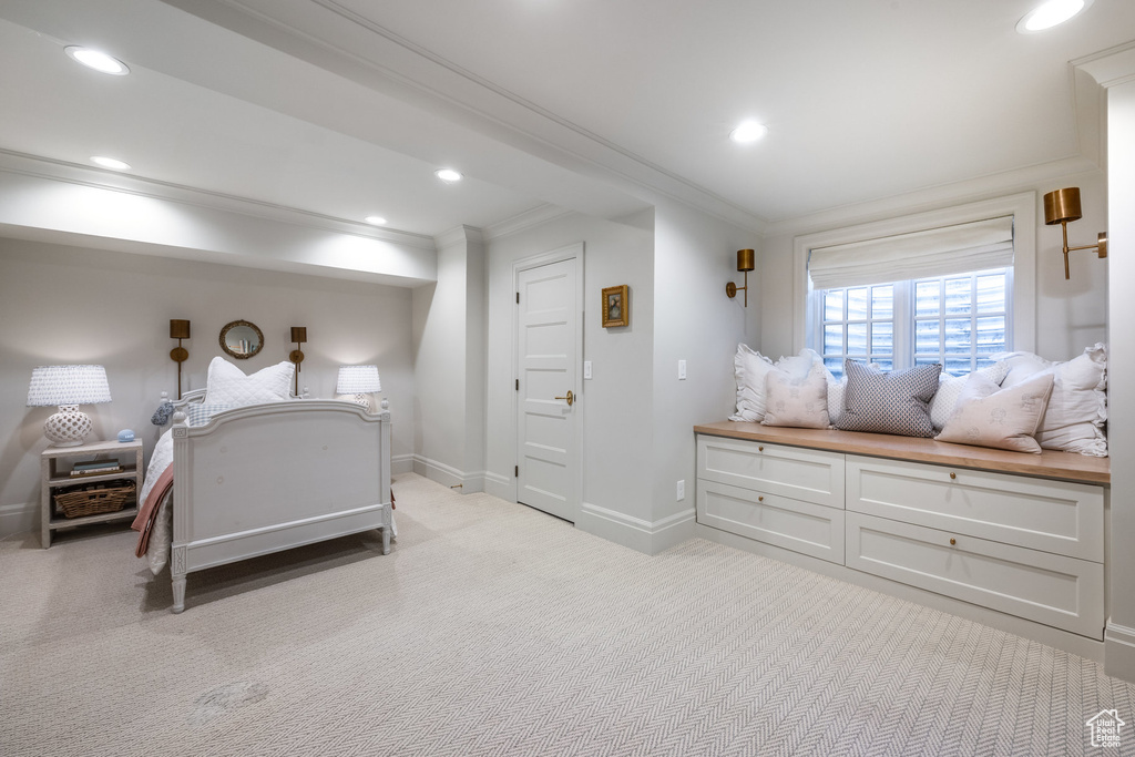 Bedroom with crown molding and light colored carpet