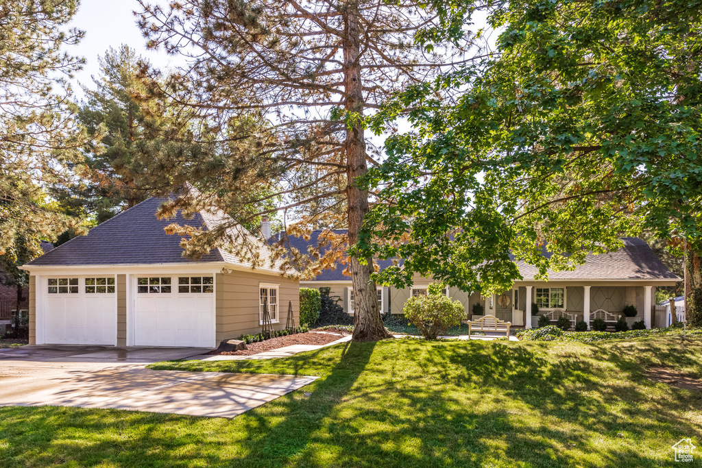 View of front facade featuring a front yard and a garage