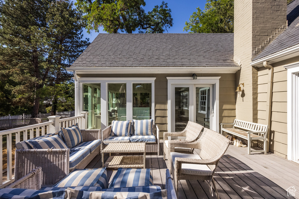 Wooden deck featuring french doors and an outdoor living space