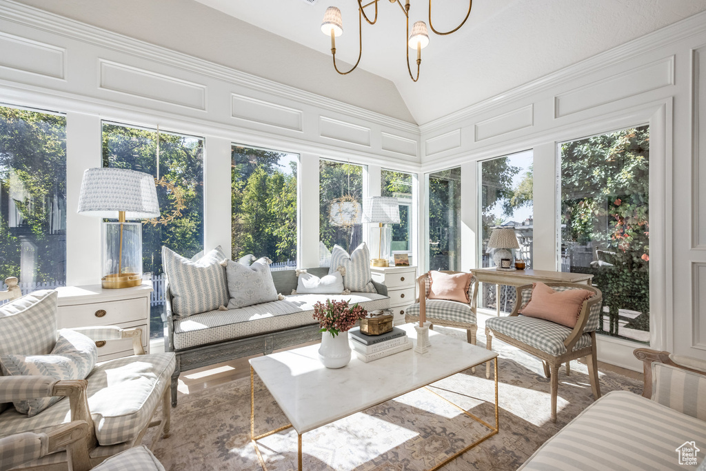 Sunroom featuring a chandelier and vaulted ceiling