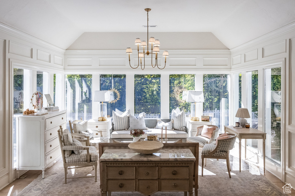 Sunroom with vaulted ceiling and a chandelier