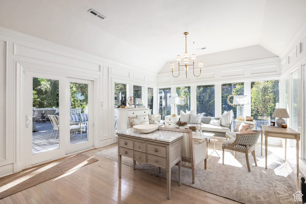 Sunroom / solarium with vaulted ceiling and a chandelier