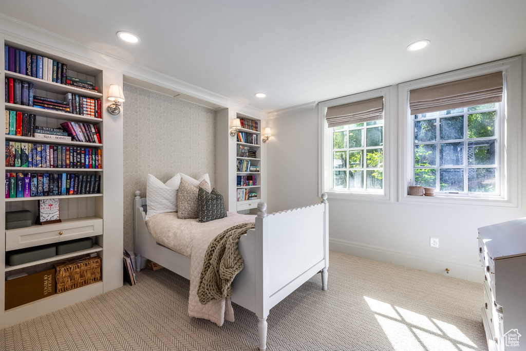 Bedroom with light carpet and ornamental molding