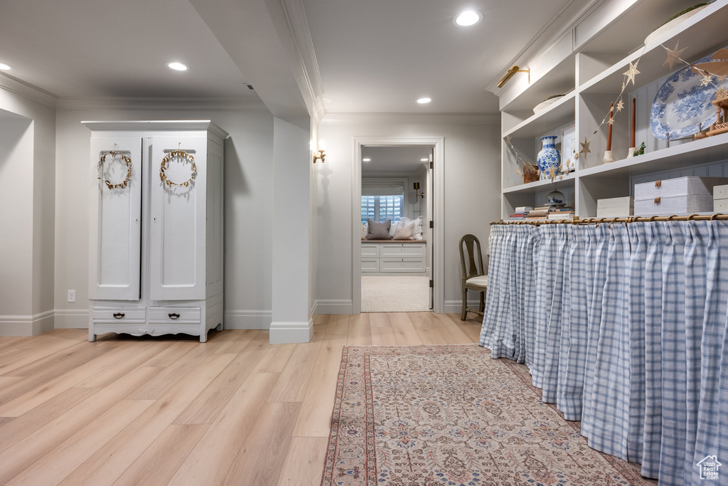 Interior space featuring ornamental molding and light wood-type flooring