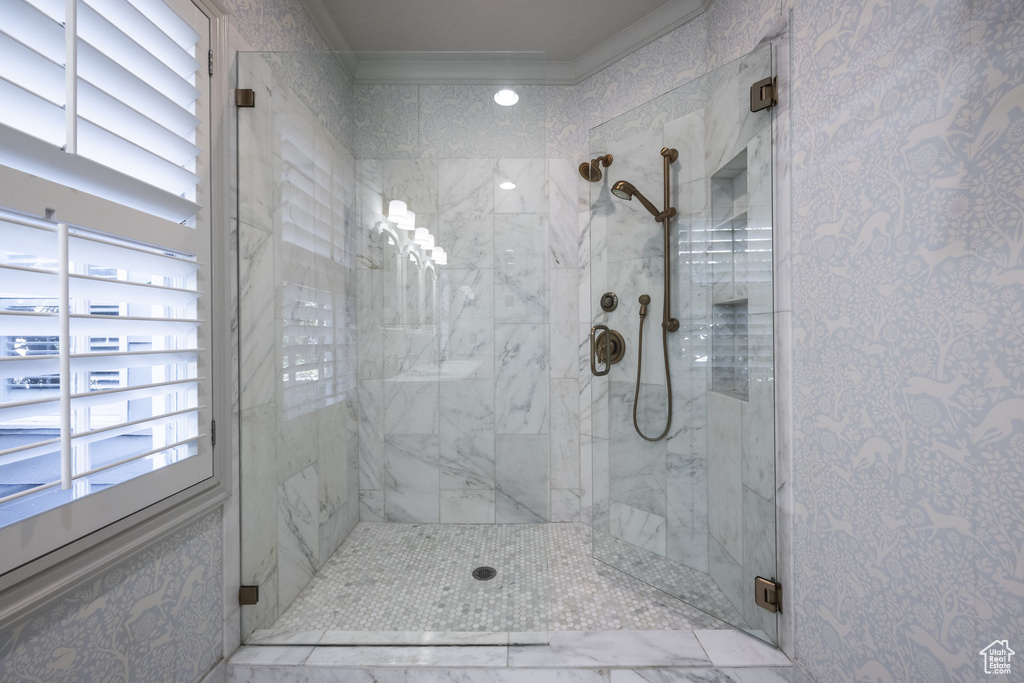 Bathroom with crown molding and walk in shower