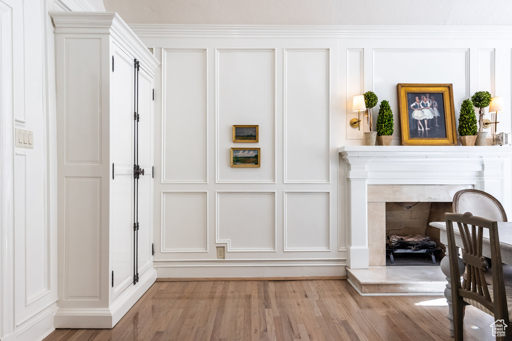 Interior space featuring crown molding, a high end fireplace, and hardwood / wood-style floors