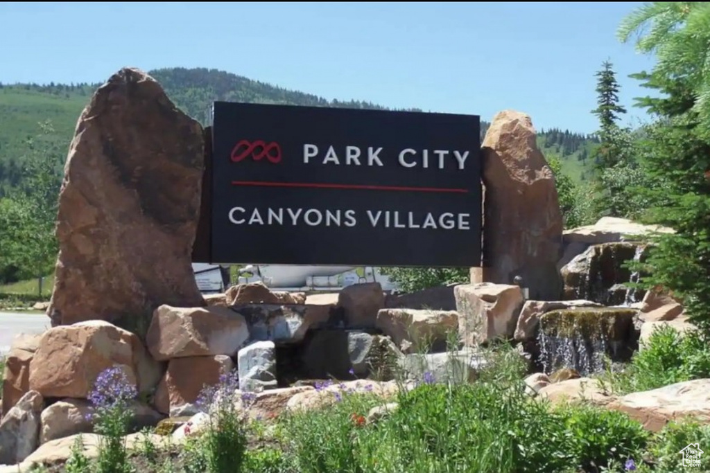 Community / neighborhood sign with a mountain view