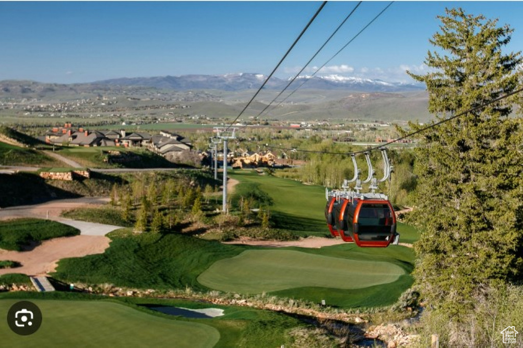 Surrounding community with a mountain view and golf course view