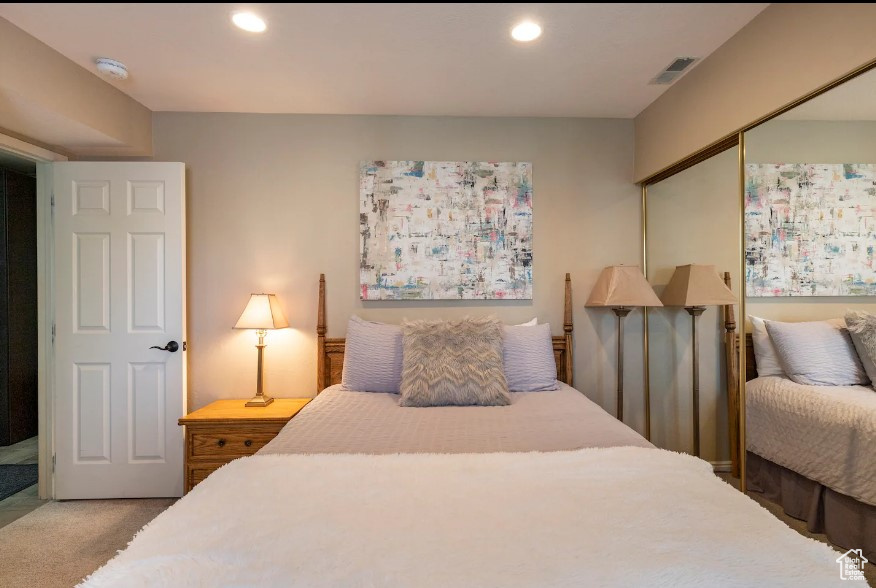 Carpeted bedroom featuring a closet