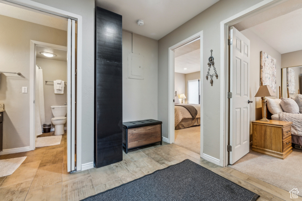 Hallway featuring baseboards and light wood-style floors